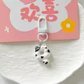 Close-up of cute donut-shaped cat keychain with black spots and silver metal clasp - Black Spotted Cat