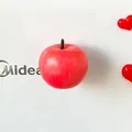 Detailed close-up view of a realistic red apple fridge magnet on a white surface - Red Apple