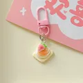 Macro view of a cute simulation strawberry cream biscuit charm on a pink keychain - Trapezoid Strawberry Ice Cream