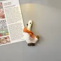 Dettaglio di un magnete da frigorifero a forma di oca in tessuto con sciarpa lavorata - Oca
