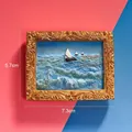Macro view of 3D miniature resin oil painting fridge magnet featuring a sailboat and gold frame - Set Sail