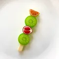 Detailed macro view of colorful fruit skewer resin charms for DIY craft making projects - Double Kiwi Skewer
