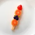 Detailed realistic resin fruit skewer charm featuring strawberry, orange, and blueberry - Double Orange Skewer