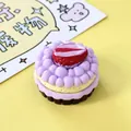 Detailed view of a miniature purple cream cake with a sliced strawberry topper for DIY - Taro Strawberry Cake