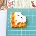 Macro detail of a cute cartoon animal biscuit resin charm for DIY hair accessories. - Bitten Cookie