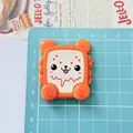 Detail view of large cartoon animal biscuit resin accessory with size scale on blue mat - Bear Bread