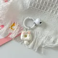 Detail view of a cute cartoon cat donut keychain accessory featuring a white bell - White Cat + White Ring + White Bell