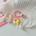 Close-up of a cute cat donut keychain with a pink bell charm and round clip accessory - Yellow Pink Cat + Pink Ring + Pink Bell