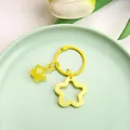 Cute yellow hollow star keychain accessory displayed on a decorative green plate - Solid Hollow Star and Jelly Star / 3cm Ring / Yellow
