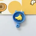 Close-up of cute blue cat-ear pan resin charm with yellow banana bunch - Banana Plate