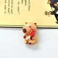 Macro view of a cute resin capybara figurine holding a red mushroom for DIY shoe charms - Mushroom Capybara 3