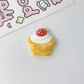Close-up of a miniature resin strawberry cupcake charm for DIY handmade jewelry crafts - Strawberry Cake