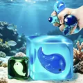 Close-up of undersea world luminous cube maltose squishy toy being squeezed for stress relief - 5.5cm Cube / OPP Packaging / Luminous Whale