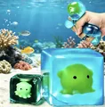Macro detail of a hand squeezing a glowing blue underwater theme cube maltose squishy toy - 5.5cm Cube / Display Box / Luminous Octopus