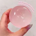 Close-up of a pink translucent slow rebound squishy stress ball held in hand - Pink