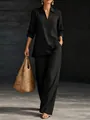 Elegante completo nero da donna con top a maniche lunghe con scollo a V e pantaloni. - Nero