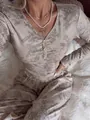 Close-up detail of a women's floral ribbed long-sleeve pajama set and cozy loungewear - S / Top And Bottom / Grey Floral