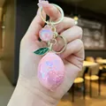 Schimmernder rosa Zitronen-Schlüsselanhänger mit goldenen Ringen und grünem Blatt - Goldene Hardware Galvanisierte Zitrone / Aurora Rosa
