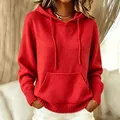 Detailed texture of vibrant red knitted hoodie featuring front pocket and drawstring. - Red
