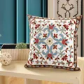 Intricate floral embroidered cotton throw pillow with ethnic patterns on a wooden table - Sunflower Shape-Blue