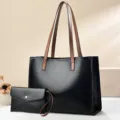 Detailed view of the large black PU tote bag and matching clutch with brown handles. - 36x14x26 / Black
