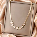 Elegant 18K gold plated snake chain necklace featuring seven white enamel star charms - Shell Star Style (N-39G)