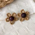 Handmade vintage woven flower earrings with dark wood center beads on beige background - Openwork Flower Style (28492A)