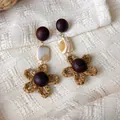 Vintage ethnic style earrings with dark wood beads and woven raffia flower charms - Shell Tassel Flower Style (28492B)