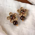 Vintage bohemian woven flower earrings featuring leopard print beads and orange accents - Bead Cluster Style (28548A)