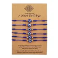 Detail view of 6 blue 7-knot evil eye protection bracelets on brown display card stock - Evil Eye (7 Knot) / 6 Pieces Set / Blue