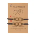 Pair of black braided cord bracelets with handcuff charms on a pinky promise card - Handcuffs Freedom Style (ZJ11500) / Set of 2 / Black