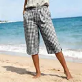 Close-up of women's black and white checkered cropped pants for summer beach holidays - S / Bottoms / Black