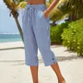 Detail of summer blue striped cropped pants with drawstring waist and side button slit. - S / Bottoms / Blue and White Stripes