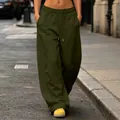 Close-up of olive green wide-leg joggers with drawstring waist and side pockets - Army Green