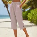 Detail view of brown striped cropped pants with drawstring waist on a sunny beach - S / Bottoms / Brown White Striped