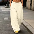 Detail view of cream high-street wide-leg sweatpants with drawstring waist in street context - Beige Apricot
