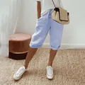 Lifestyle detail of women's light blue cotton linen capri pants with elastic waist and pockets - S / Bottoms / Light Blue