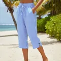 Detailed view of women's blue and white striped cropped pants on a beach setting - S / Bottoms / Blue and White Stripes