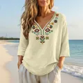 Detail of boho embroidered linen top with V-neck and 3/4 sleeves on beach background. - S / Tops / Off White