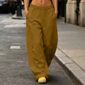 Detailed view of baggy wide-leg sweatpants with drawstring waist in urban street setting - S / Bottoms / Caramel Brown
