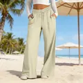 Détail d'un pantalon beige à taille haute et jambe large sur la plage - S / Bas / Beige Clair