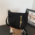 Stylish black shoulder bag with metal star pendant, versatile crossbody bag for daily use. - Black