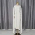 Gedetailleerd overzicht van een elegante witte avondjurk met cape-ontwerp en mouwloze snit - Wit