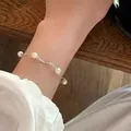 Detailed close-up view of the minimalist wavy silver pearl bracelet worn elegantly on a wrist. - Wavy Artificial Pearl Style (MY36045)
