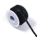 Detailed view of black rhinestone cord spooling, ideal for clothing and DIY crafts. - Black