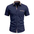 Short-sleeve navy shirt featuring a plaid contrast collar and single chest pocket - S / Tops / Burgundy