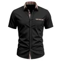 Black short-sleeved men's shirt with plaid contrast collar and chest pocket details. - S / Tops / Black