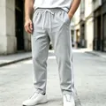 Detail of men's grey sports sweatpants with side stripes and drawstring waist - Light Gray
