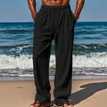 Detail view of men's loose black linen pants with drawstring waist at a sunny beach. - S / Bottoms / Black