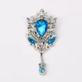 Detailed macro shot of a vintage palace style brooch with blue crystal and rhinestones. - Light Blue